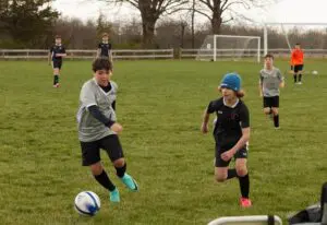 Oliver Reich (left) controls the ball for the U13 Fusion in an April 14 game at Red Hook.