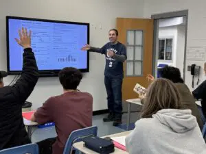 Christian Hoolan leads a lesson on electricity costs during a math class at Haldane High School.