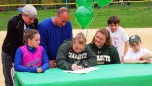 Surrounded by her family, Chelsea Lisikatos signs her letter of intent