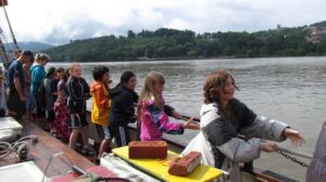 Students help hoist the Mystic Whaler's main sail