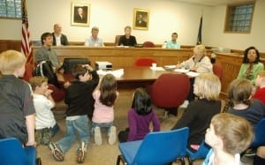 NASA scientist Timothy Hall (left at table) and Village Board members take questions during the Earth Day discussion at Tuesday’s meeting.