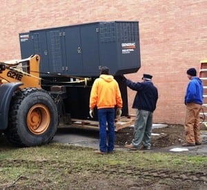Roger Chirico, middle, supervises generator delivery as John Van Tassel, right, looks on. 2