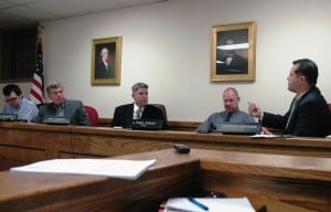 Trustee Airinhos Serradas (far right) debates with Mayor Seth Gallagher (center) and Trustee Bruce Campbell (center left) while Trustees Chuck Hustis (