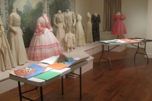 Saunders History Contest projects displayed with the museum's costume exhibit as a colorful backdrop (Photo by A. Rooney)