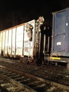 CSFC firefighters scale the box car that caught fire just south of the Cold Spring train platform.