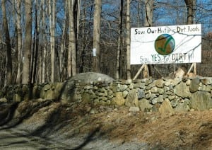 A sign in March on Old Albany Post Road opposes paving and promotes a dirt-road advocacy website. Photo by L.S. Armstrong