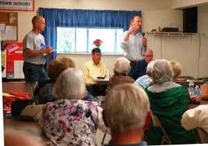 As John Van Tassel takes notes, Richard Shea fields comments from senior citizens gathered at Chestnut Ridge. Photo by L.S. Armstrong