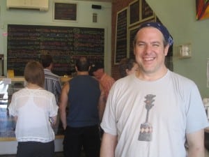 A steady stream of customers lines up behind Beacon Bagel's Art Burns.