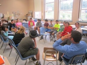 Haldane Principal Brent Harrington (back to camera, blue shirt) listens along with the class as writers share their essays.
