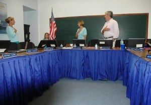 The Pledge of Allegiance heads the agenda at the GUFS meeting, with Superintendent Gloria Colucci, center left, and Board President Raymond O'Rourke, center right, joining in, alongside Board Member Theresa Orlandi, left, and a young flag-bearer. Photo by L.S. Armstrong