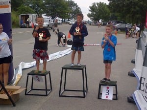 Zane del Pozo, center, takes top honors at the Boston Triathlon. (Photo courtesy of Brandon del Pozo)