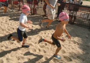 Zane del Pozo, right, heading from the swimming to the biking component at Croton's TOUGHKids Triathlon.