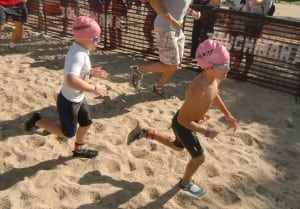 Zane del Pozo, right, heading from the swimming to the biking component at Croton's  TOUGHKids Triathlon.