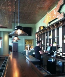 A directional sign from the old Mt. Beacon ski resort hangs over the bar. Hudson Beach Glass designed and produced the lights.