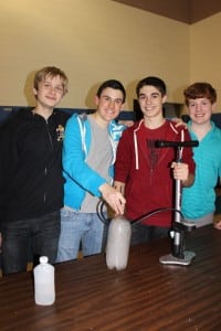 Members of the O'Neill Science Club participate at their "Cloud In A Bottle" condensation demonstration table. 