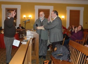 Putnam County Clerk Dennis Sant, left, administers the oath of office to newly appointed Legislator Louis Tartaro, right, as an unidentified man holds the Bible. (Photo by L.S. Armstrong)