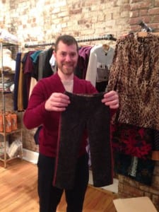 Evan Ross sizes up a just-unpacked pair of boys' pants from Swing's new line.