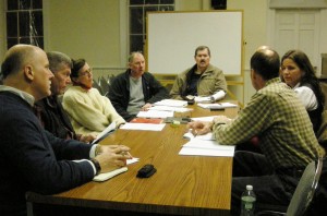 Members of the Cold Spring Village and Philipstown Town Boards Feb. 26 discuss building department consolidation and creation of a water district. They are, around the table, from near left: Cold Spring Trustees Matt Francisco, Bruce Campbell, and Stephanie Hawkins and Mayor Ralph Falloon, and Town Board Members Mike Leonard and Nancy Montgomery, with Supervisor Richard Shea (back to camera); not visible: Town Board Member John Van Tassel. Photo by L.S. Armstrong