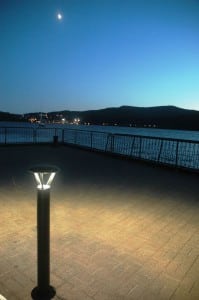 A partial moon hangs above the Hudson River at the Cold Spring dock, with the lights of West Point in the background across the river. (Photo by L.S. Armstrong)