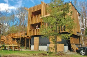 Architect James Hartford, in second-floor window, and his firm designed the passive house under construction in Cold Spring.