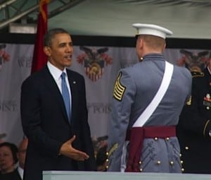 A graduate receives congratulations from the commander in chief.