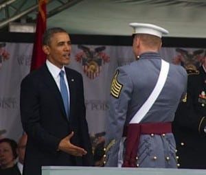 A graduate receives congratulations from the commander in chief.