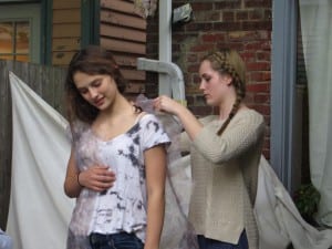 Student designer Marina Martin, right, makes an adjustment on her garment, to be worn by model Brooke Vahos. (Photo by Allison Marino)
