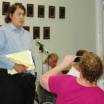 As a friend records the moment, Russ Cusick tells the Town Board of his storm-water concerns. Photo by L.S. Armstrong