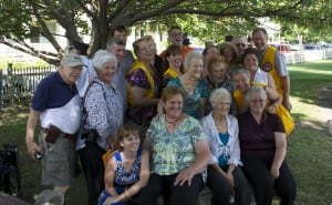 Lions Club members surround Betty Budney, seated center, and her daughters Cathy Greenough, left and Denise Brewer.