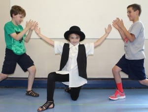 Sofia Wallis, Edward Bauer, left, and Evan Tighe rehearse the Bottle Dance musical number. Photo by Linda Speziale