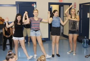 Balancing acting: an early rehearsal for the Bottle Dance number in the teen production. Photo by A. Rooney