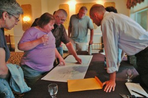 Attendees discuss elements of a draft map of the trail.
