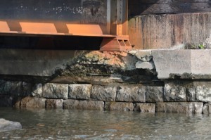 Concrete has crumbled beneath one of the bridge's vertical supports.