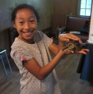 A delighted attendee holds a turtle during the first World Wildlife program. 