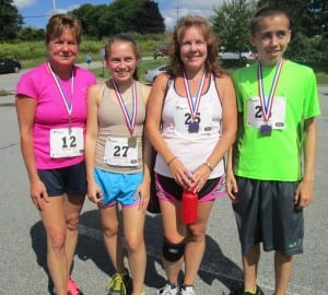 From left, Patricia Benitez, 30:59, first 50-59 year old female; Angela Castronuovo, 26:07, first 13-15 female; mom Kelli Castronuovo, 28:06, third 40-49 female; and Vincent Castronuovo, 20:47, first 13-15 male. 