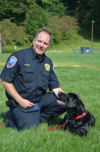 Detective John Peters and Daisy — A working arson dog, Daisy is also the Peters' family dog.