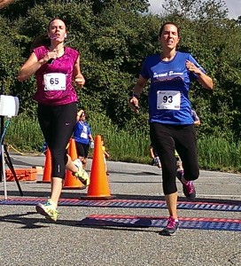 Lori-Beth Patsey, right, edges out Amanda Legace, to win top female honors. Patsey's time was 25:15.3 to Legace's 25:15.8.