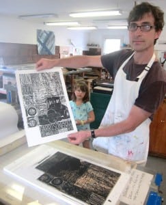 Printmaker Jeff White creates a woodblock print.