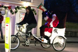 Santa arrives for tree-lighting celebration driven by John Miles of People’s Bicycle.