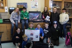 The sixth grade ecology class, posing around the tank containing El Duque.  (Photo by A. Rooney)