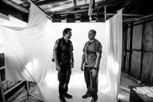 Photographer Daniel Berehulak, left, with one of his health worker subjects in makeshift studio