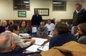 On a frigid evening, volunteer Planning Board and HDRB members reviewed Butterfield plans with developer, standing, center. (Photo by K.E. Foley)