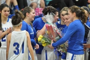 Allie Monteleone, right with flowers, during pregame ceremony