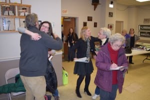 Dave Merandy gets a hug fron his wife Stephanie Hawkins while Marie Early (right) pours over the numbers one more time and Fran Murphy, second from right, receives congratulations.