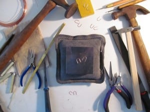 Tools of Micah Parker's trade surround her horseshoe earrings.