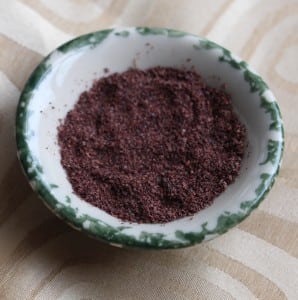 Sprinkle sumac on fatta to finish the dish.