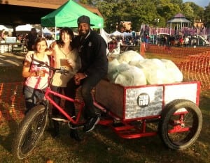 Zero to Go's Sarah Womer, left, and Ali T. Muhammad, right, catch up with a friend while collecting compostable materials at the Hudson Hop & Harvest Festival in Peekskill in October 2014.