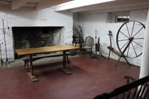 A large colonial kitchen, replete with hearth and spinning wheel, at Mount Gulian