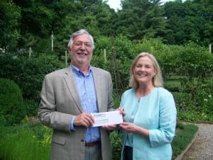 Steven Miller, Boscobel executive director, presents a check to Anne Endler, president of Philipstown Garden Club, amid beds of flax, sage, lemon verbena and more — all tended by the PGC for the past 50-plus years. Photo courtesy of Boscobel