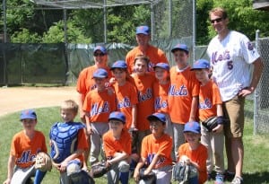Little League: Philipstown Little League Minor Mets celebrate their winning championship with coaches Stacey Twoguns, left, Lee Erickson, center, and Scott Higbee, right.